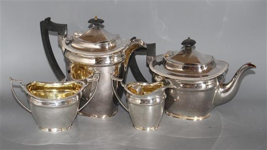 A silver plated four piece tea set, with an associated pair of plated sugar tongs